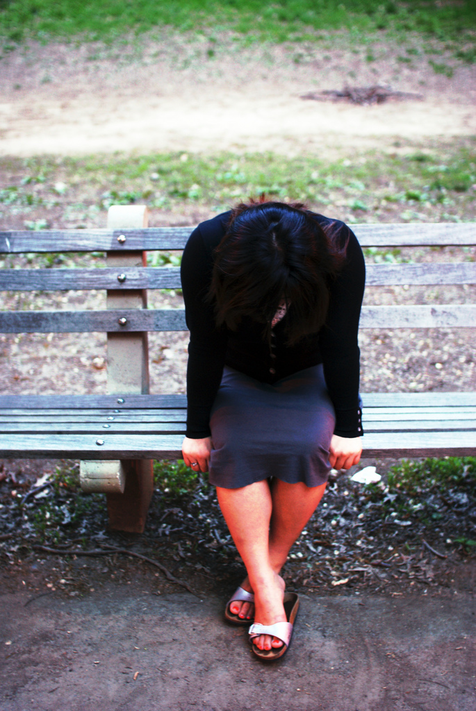 Crying girl on bench
