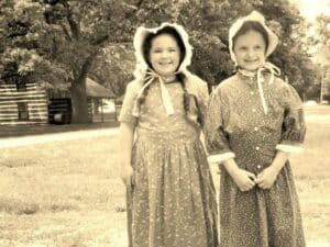 two girls dressed in prairie style
