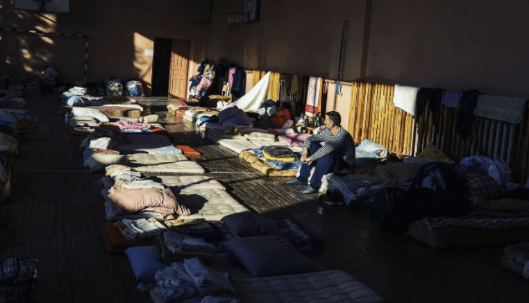Lutzk photo by Brendan Hoffman of people sleeping on the floor