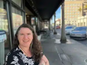 Becky McCray with downtown street and business behind her