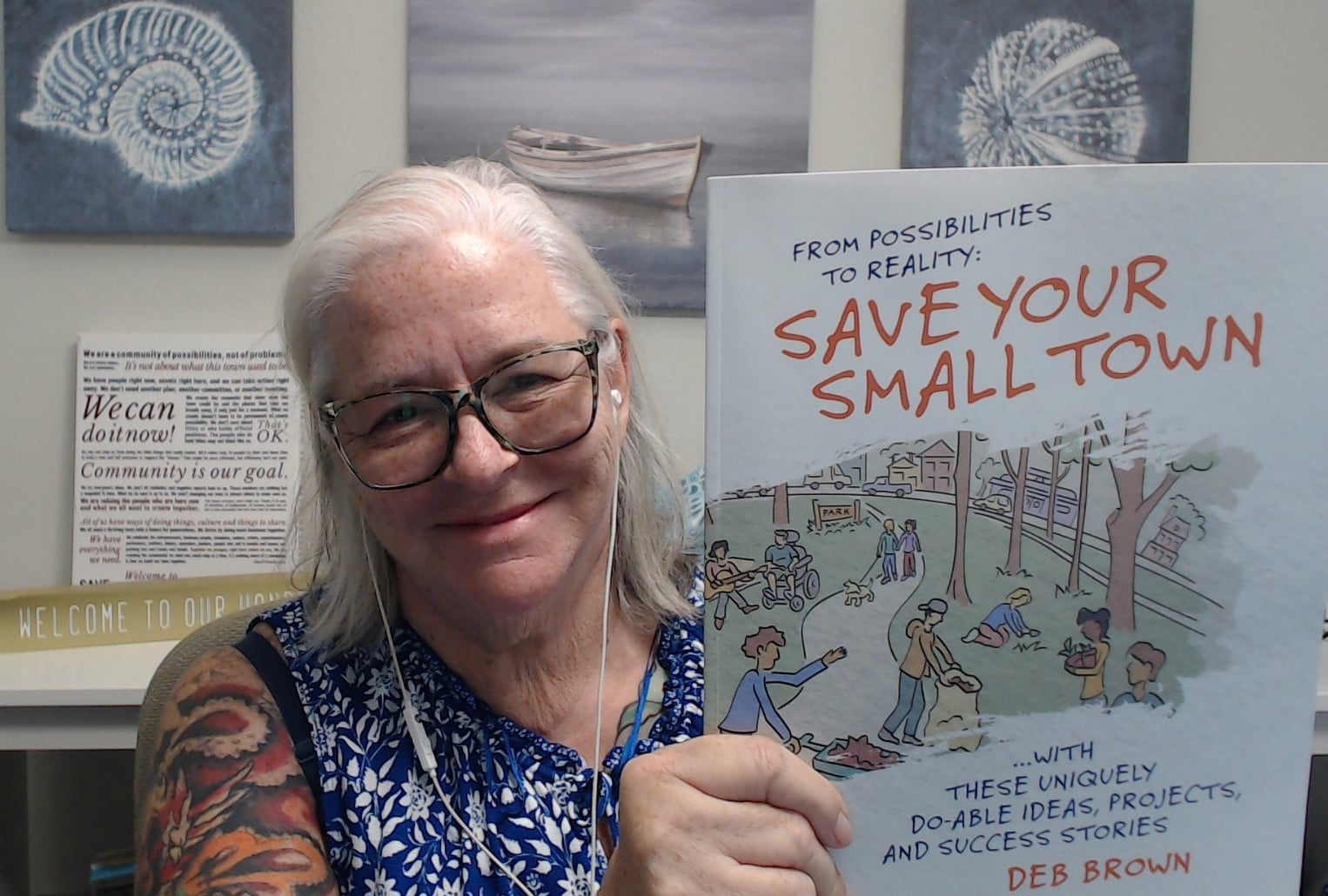 Deb Brown holds her book From Possibilities to Reality: Save Your Small Town. Click on the picture to be taken to the link to purchase.