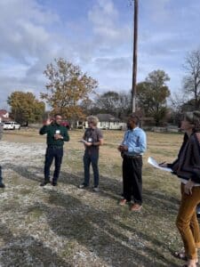 a group of people outdoors standing talking about wht they see