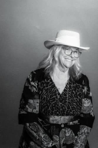black and white photo of Deb wearing a wide brimmed white hat
