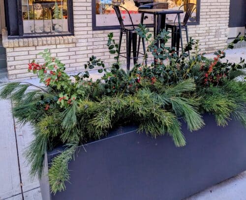 planter in front of a story with lovely winter greenery