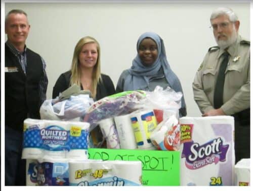 Brook, two high school students, and the local sheriff in front of their collection. Photo by Deb Brown