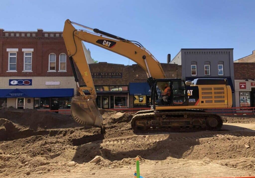 people watch the big hole the diggers are making