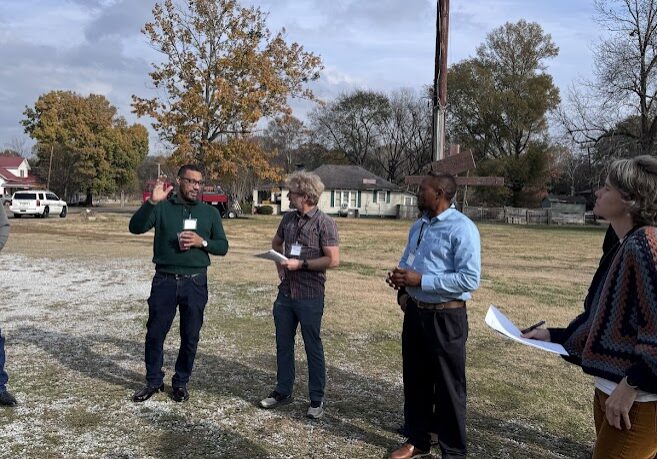 a group of people outdoors standing talking about wht they see